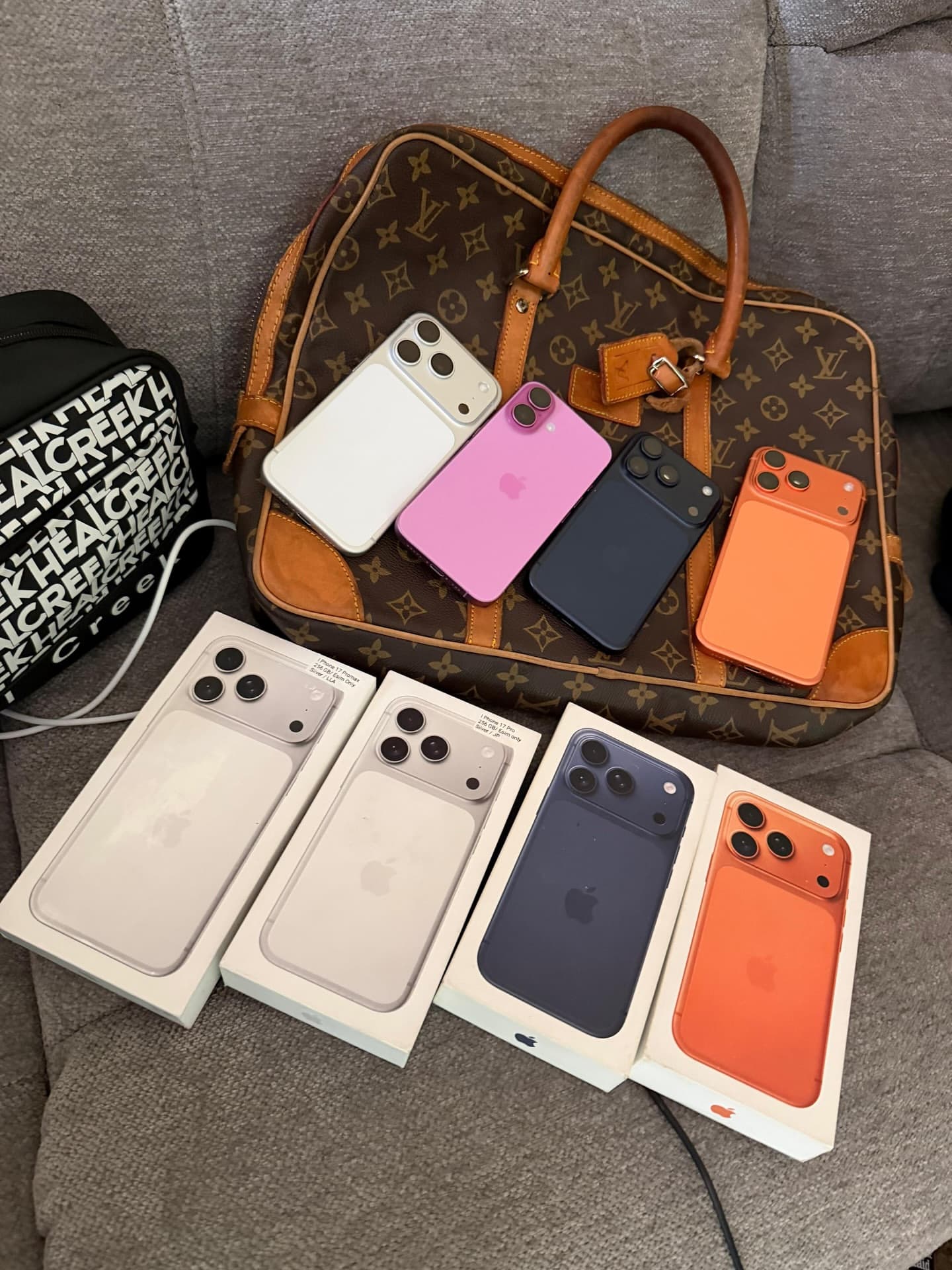 Lifestyle iPhone arrangement on designer bags