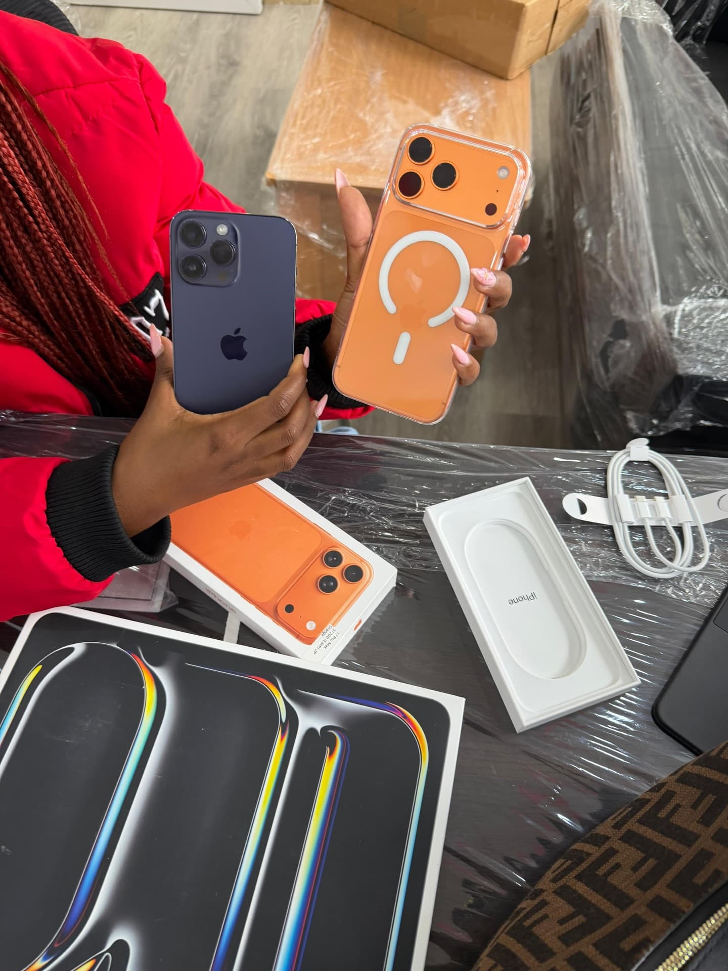 Customer holding iPhones and accessories during an unboxing moment